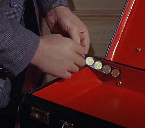 James Bond “From Russia with Love” film (1963), scene at 0:22 hour, “Q” showing attache case concealing 50 Gold Sovereigns