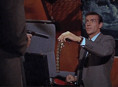 James Bond “From Russia with Love” film (1963), scene at 1:33 hours, Gold Sovereigns used as a distraction